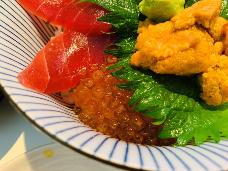 海鮮問屋つきじかんのの「まぐろ入り三種盛り丼」。濃厚なうに、プチプチのいくら、ねっとりしたまぐろ赤身が贅沢に乗った築地場外市場の看板メニュー